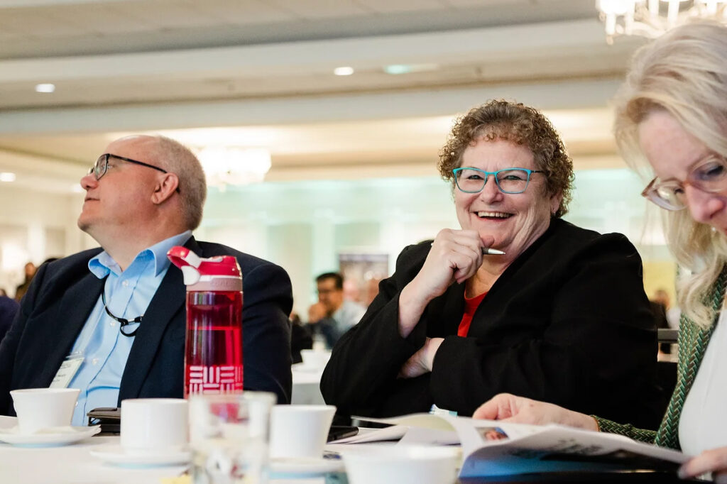 Conference Table Smiling Attendee